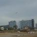 Ibiza playa d'en bossa rain: gray sky seen from the beach, a plane flies over